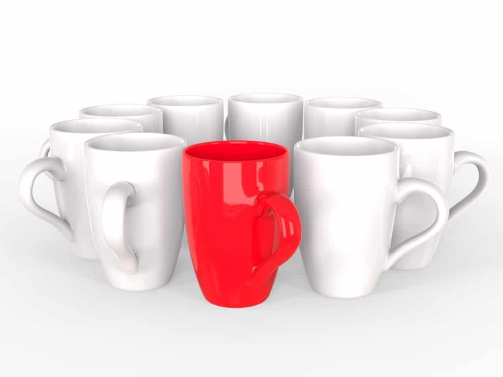 Red coffee mug stands out of circle
