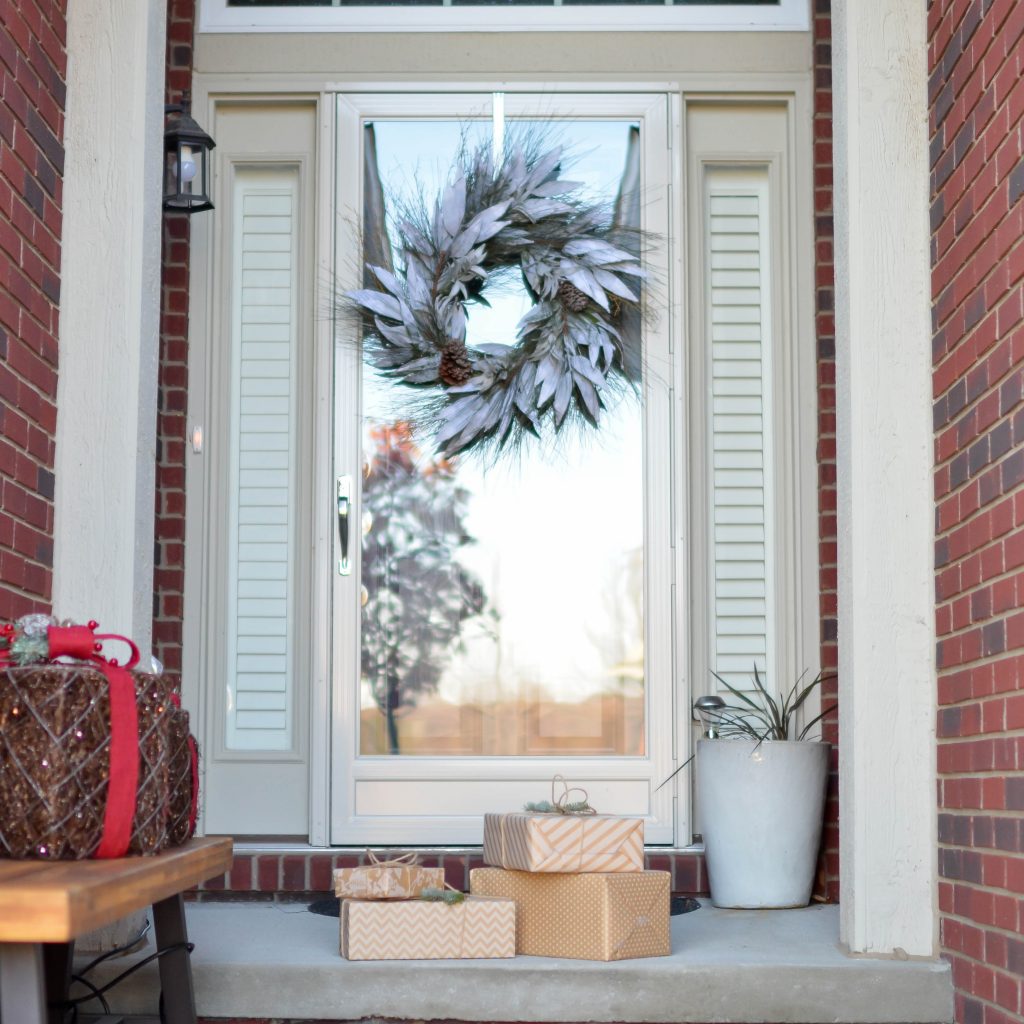 Nicely wrapped presents at a front door steps during the holiday season.