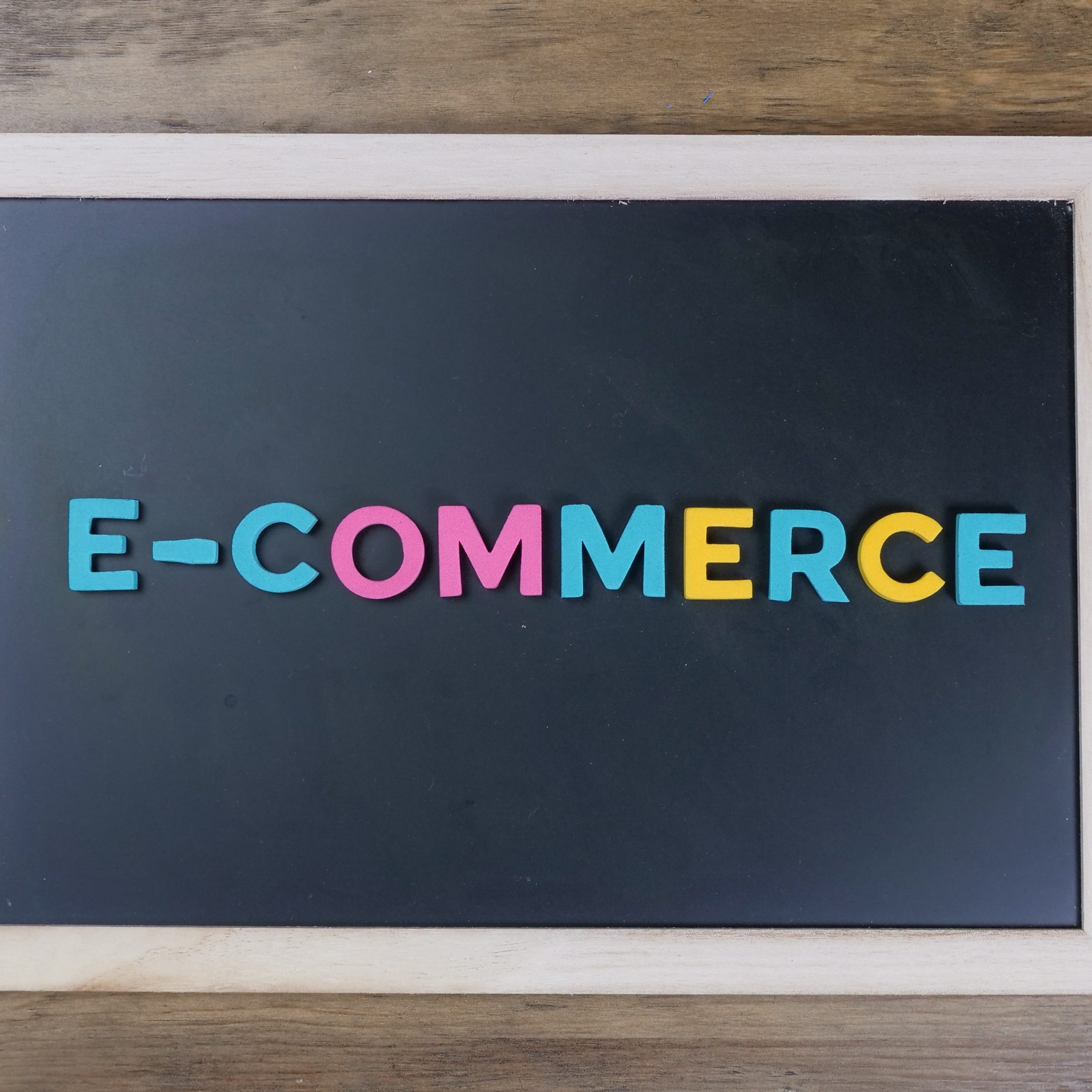 words e-commerce in color on a black board